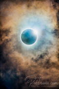 Amber solar eclipse with clouds